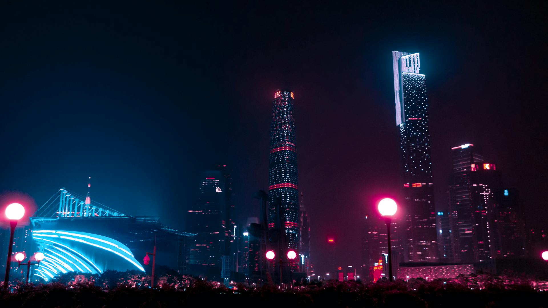 Illuminated skyscrapers and street lights in Guangzhou create a stunning night cityscape.